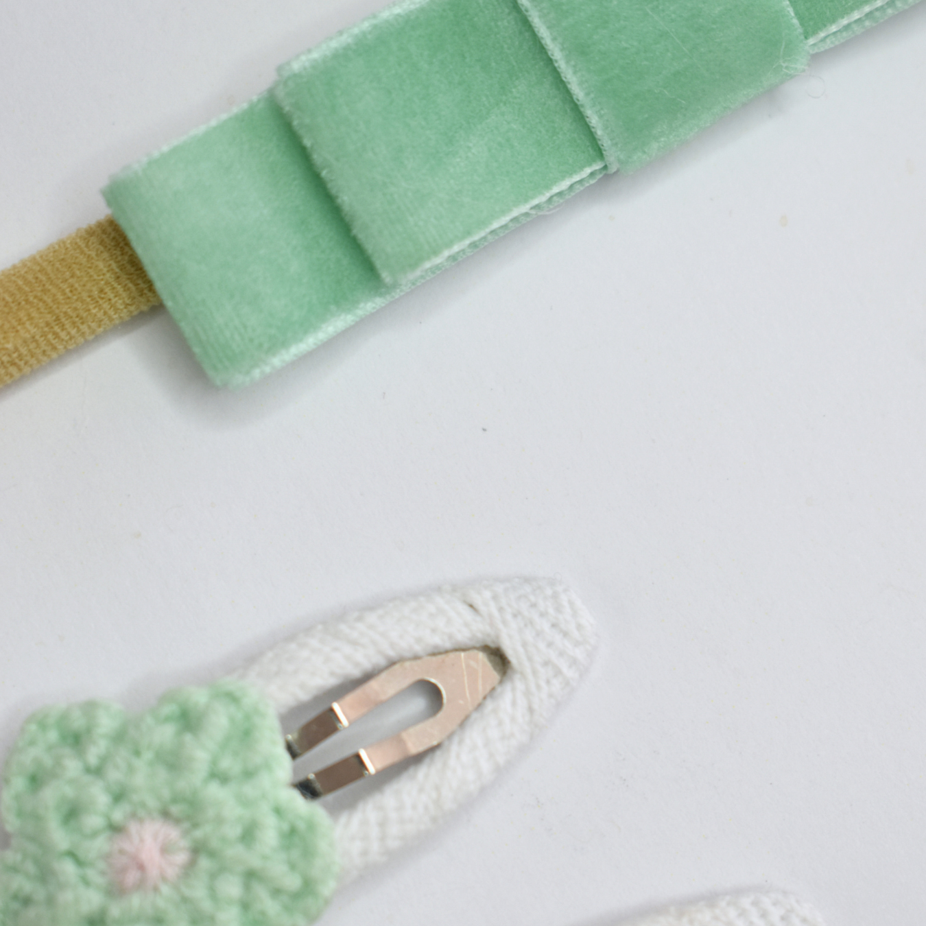 Green headband with a bow and matching crochet flower